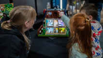 Mother and two young children looking at a LEGO display at Brickish Weekend
