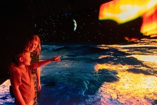 A mother and son enjoying the Other Worlds experience
