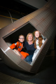 Mother and two children in spacesuits in the Mercury capsule in Into Space gallery