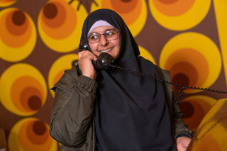 Lady on the phone in the 1969 sitting room in the Rocket Tower