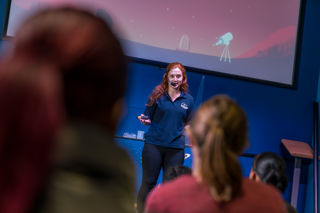 Science Communicator presenting on the LIVE Space stage