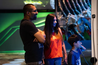 Family watching their video in the Home Planet gallery