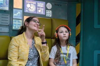 Mother and child with ear defenders in Tetrastar on an Accessible Afternoon