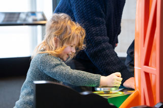 Young boy happily interacting in the Rocket Tower