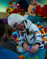Young child in a spacesuit in the Duplo Brick Pit