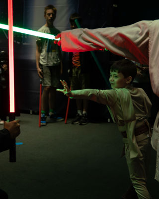 Young Jedi with a Lightsaber uses the Force push at Galactic Gathering