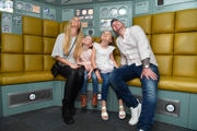 Family looking happily at the view of Earth in the escape pod