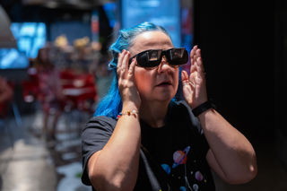 A Person tries on space glasses in the galleries