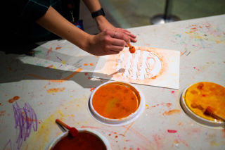 A pair of hands take part in a Jupiter craft activity