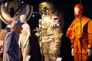 Older man looking at the spacesuit display in the welcome hall