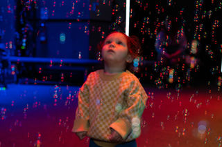 Toddler in wonder at bubbles in LIVE Space