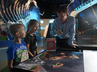 Children engaging with a talk at a Space LATES event
