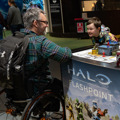 Man in a wheelchair and a happy child playing a game at To Boldly Game
