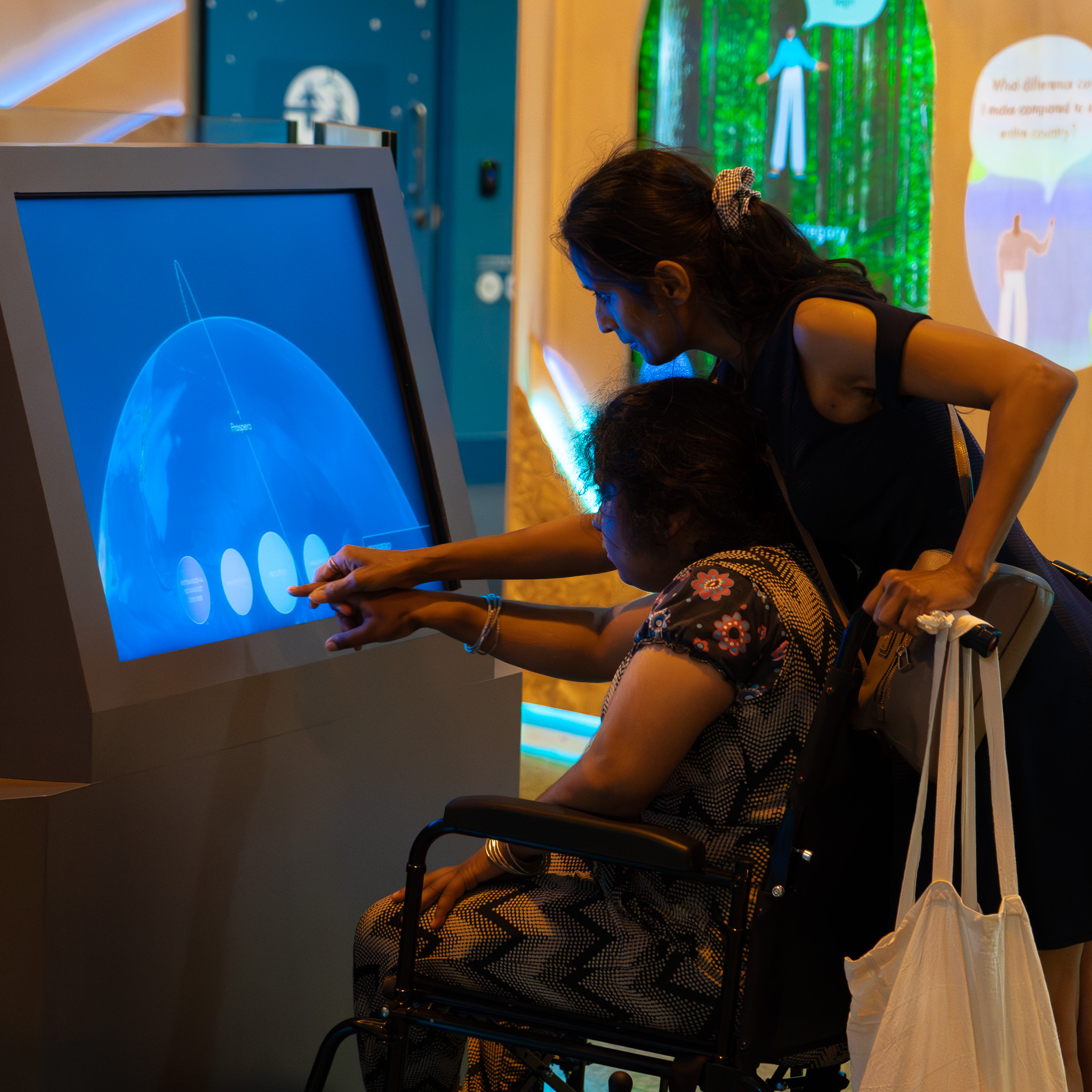 Mother and child in a wheelchair interacting in Home Planet at Accessible Afternoons