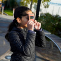 Young girl using an Eclipse Viewer to watch the solar eclipse safely