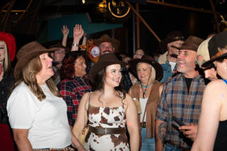 People in Stetsons singing along at Cosmic Country