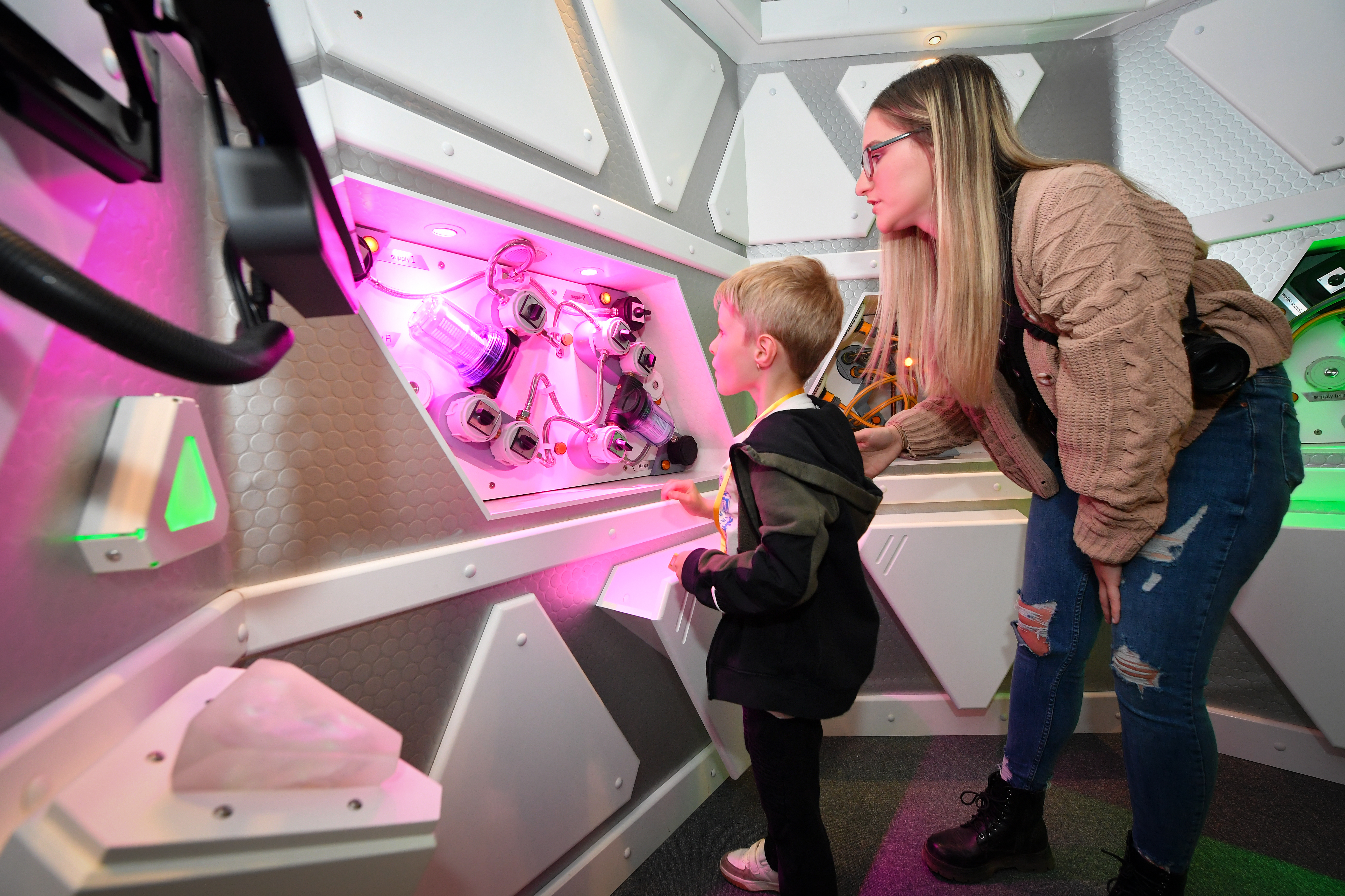 Mother and child running a science experiment in Tetrastar Spaceport lab