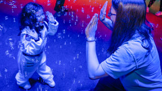 Happy child and mother with bubbles at Sensory play at Small Space Day