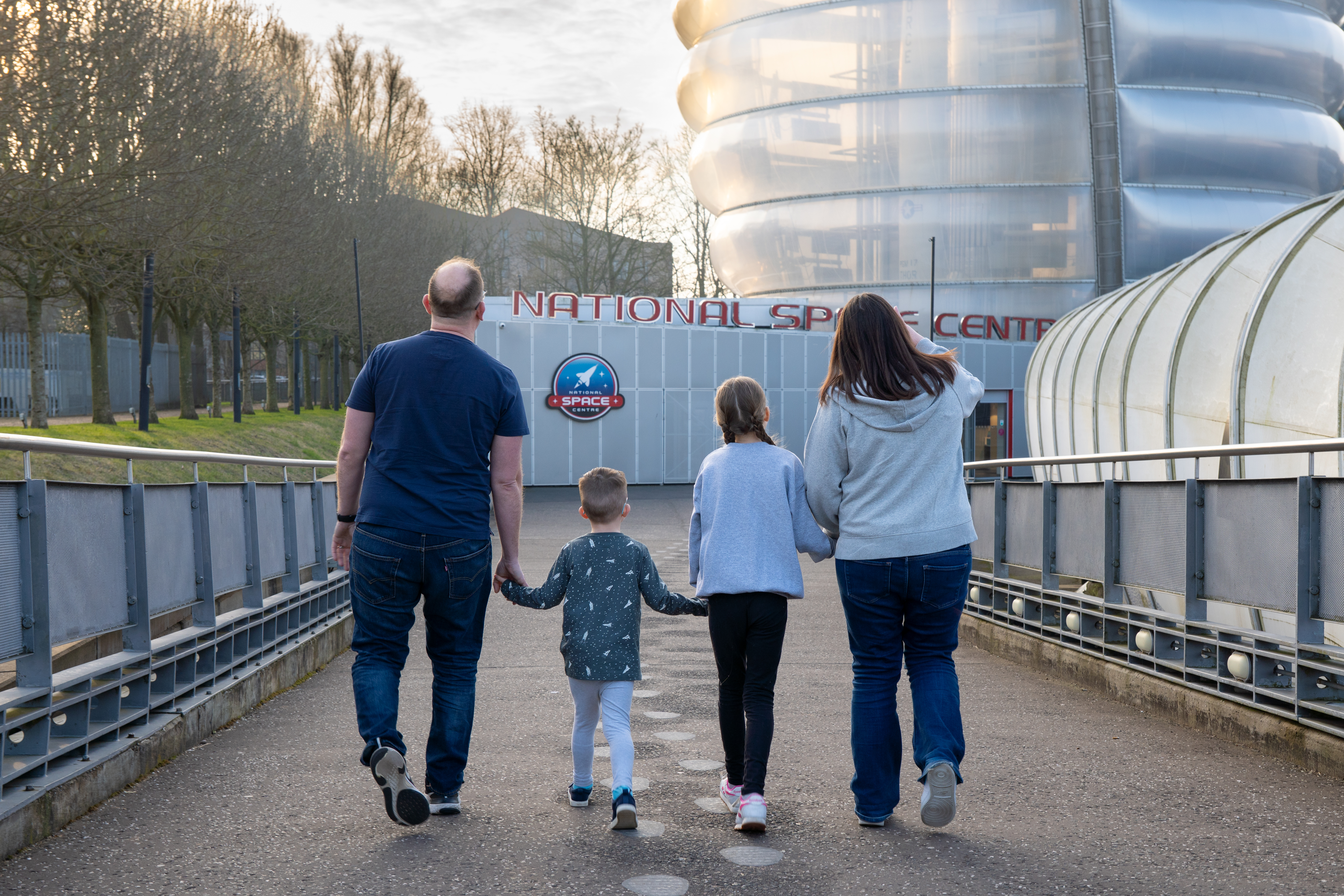 Family arriving at the Centre walking down the ramp
