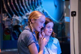 Two children watching their video in the Home Planet gallery 