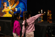 Two young girls looking at the LEGO Beauty and the Beast display