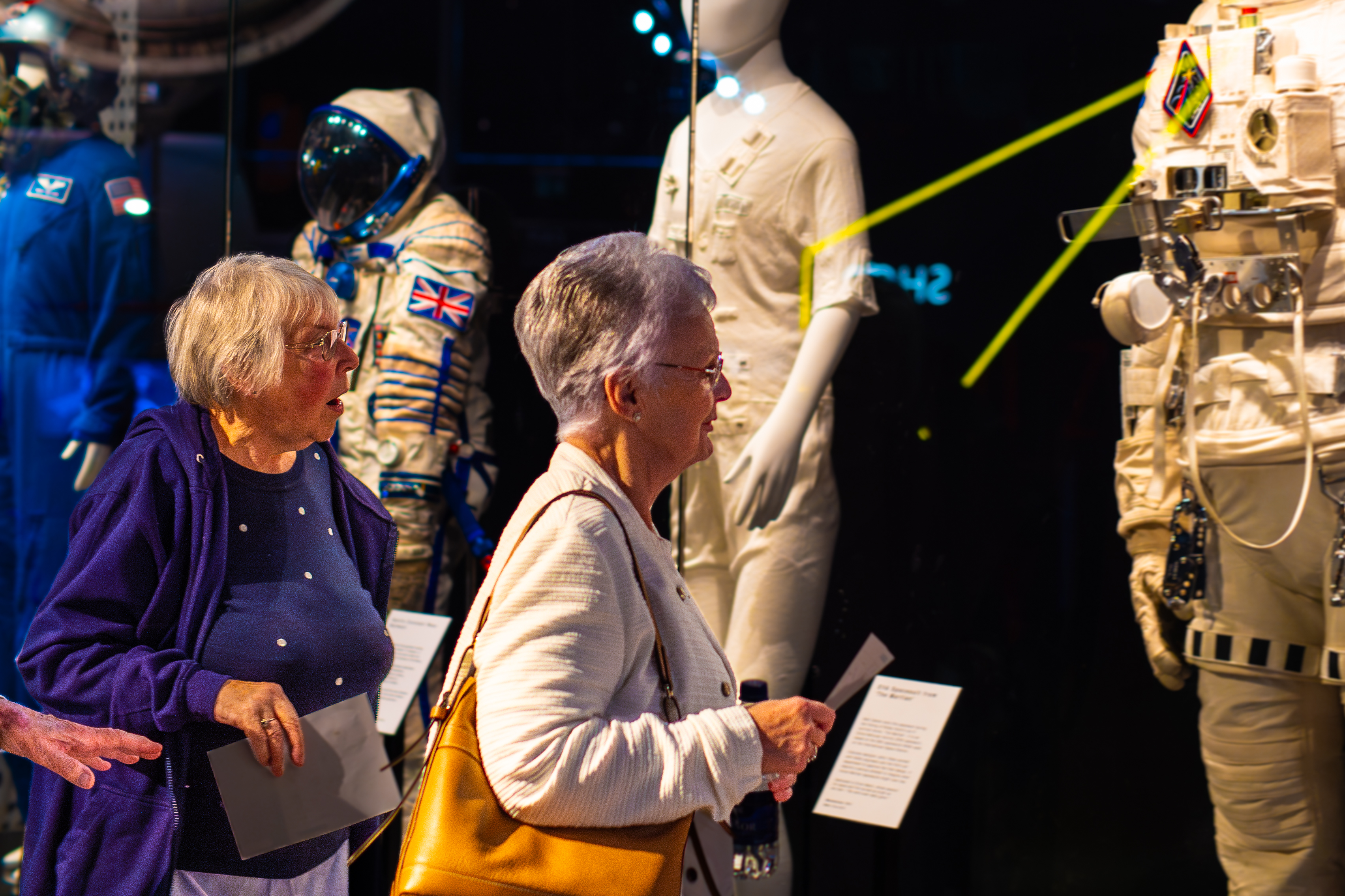 Two older ladies looking at the spacesuits in the Welcome Hall