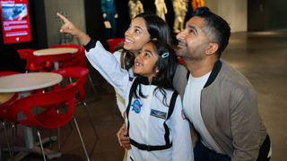 Family looking at the Soyuz capsule in the Welcome Hall
