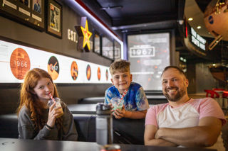 Family enjoying milkshakes in the Soyuz Lounge cafe