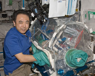 JAXA astronaut Satoshi Furukawa using a box to build LEGO onboard the ISS.