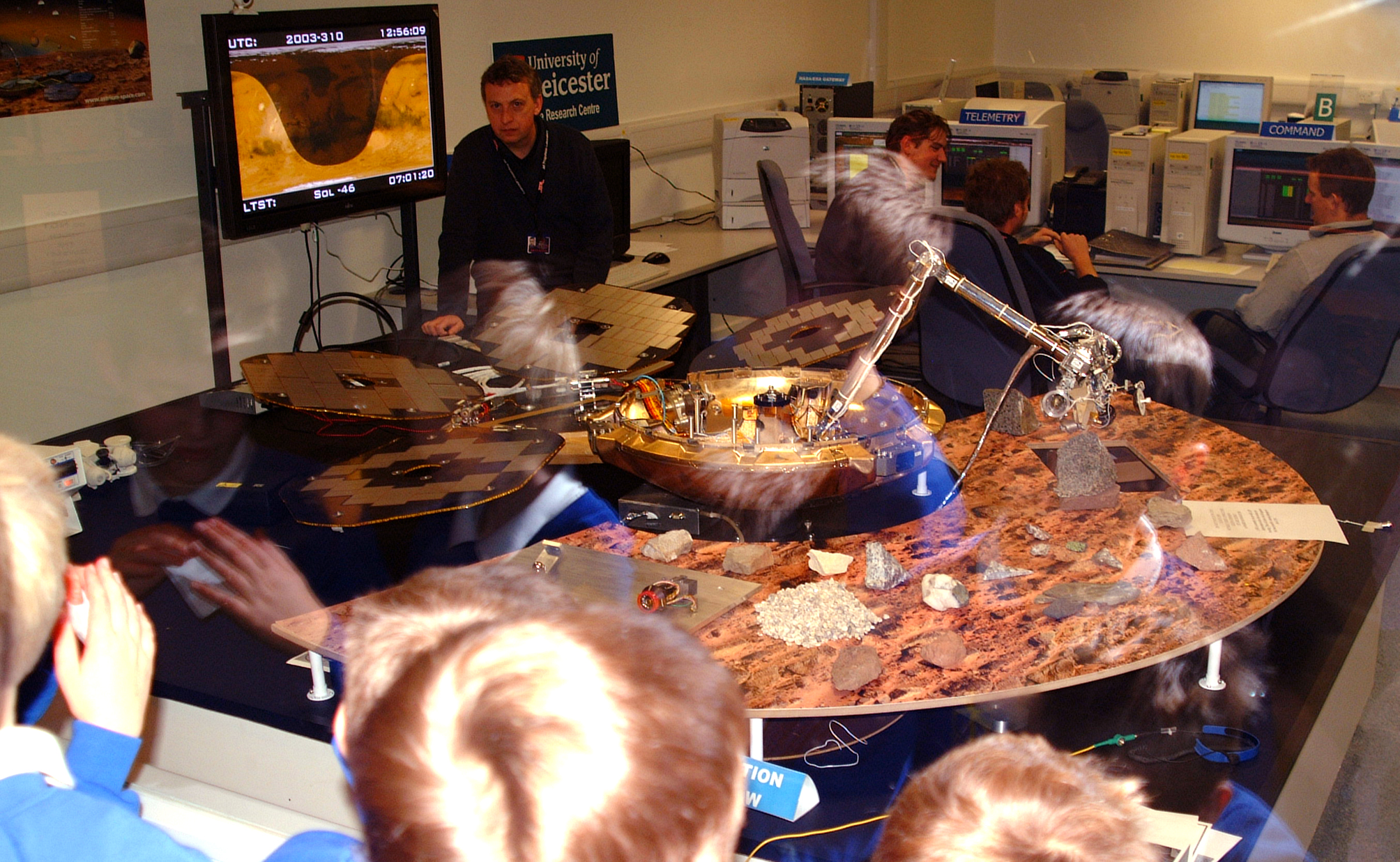 The Beagle 2 team working in view of some excited school children.