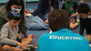 Education facilitator leading an SEN workshop with children and parents