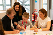 Family participating in a STEAM Academy session at Galactic Gathering